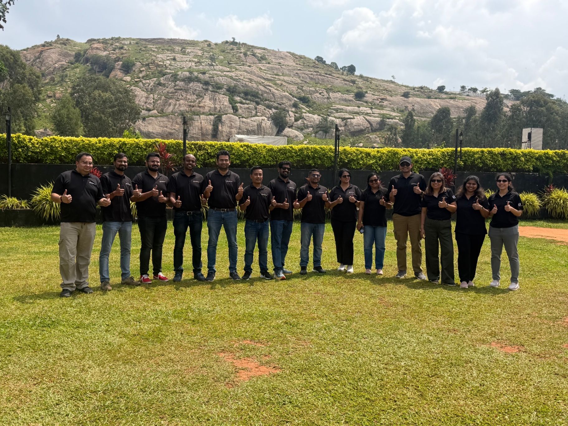 Occasia One corporate team offsite group photo at a hill-side venue near Bengaluru